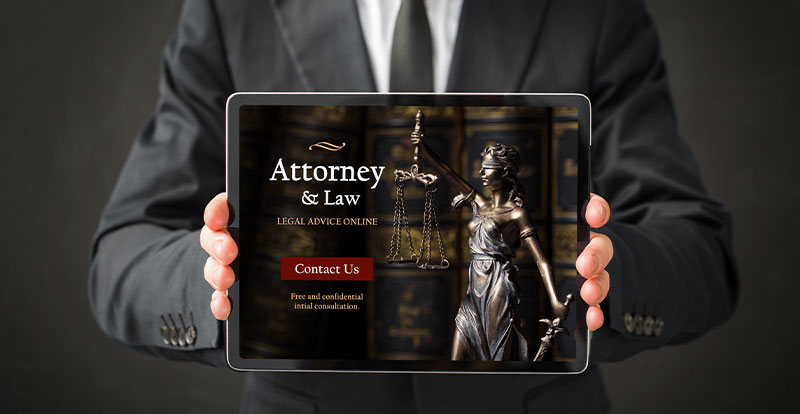 Man in suit holding up mobile device with attorney website